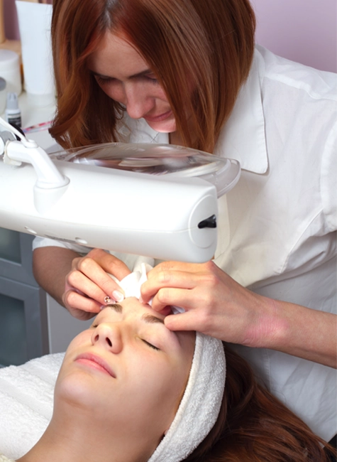 girl receiving a facial focusing on acne