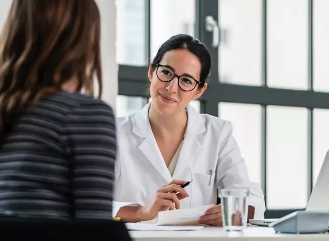 woman receiving a consultation for acne treatment with a medical professional