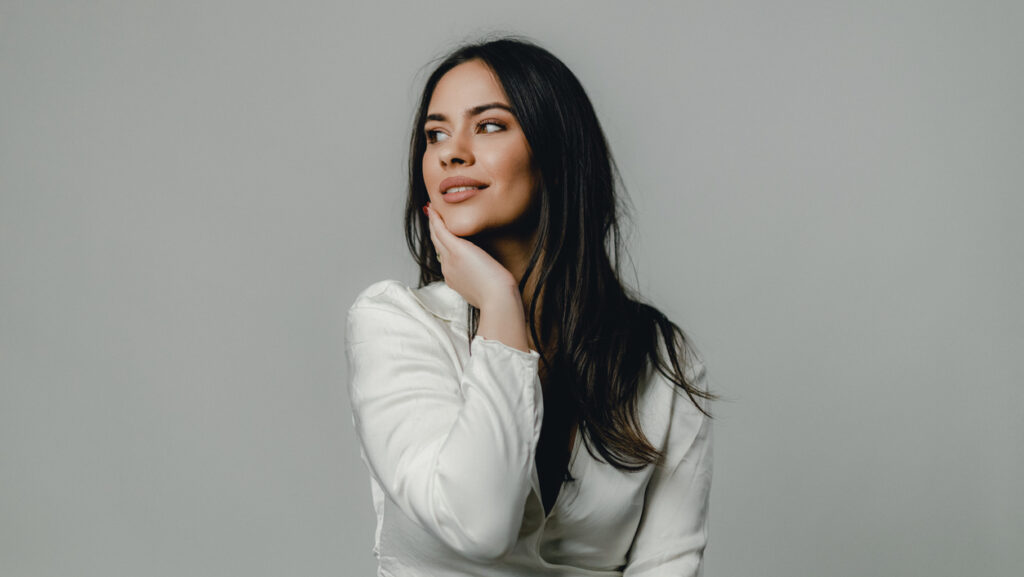 Portrait of a young woman with radiant skin, showcasing results of a VI Peel treatment